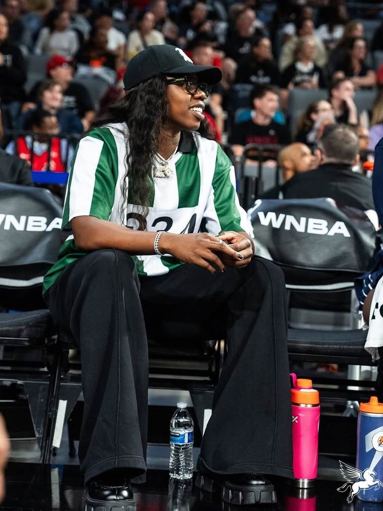 Arike Ogunbowale courtside in a +234 jersey