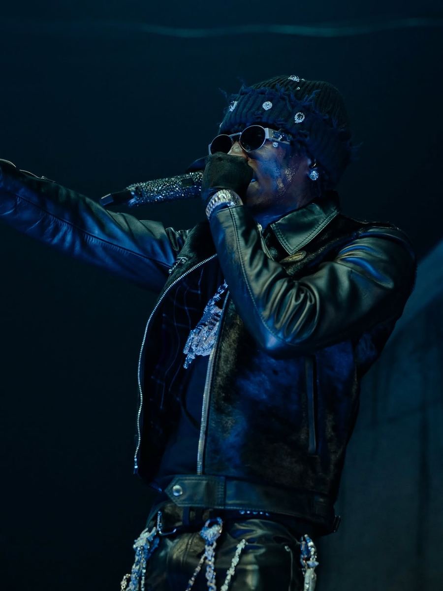 NBA YoungBoy performing in an Againsttheoddz distressed beanie